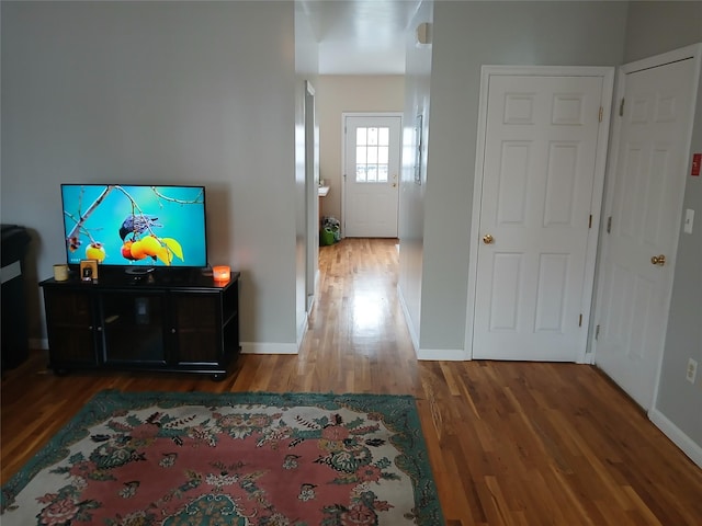 interior space with baseboards and wood finished floors