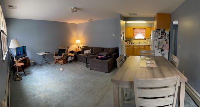 carpeted living room featuring a sink and visible vents