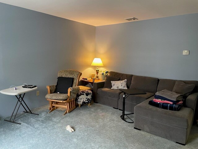living room featuring carpet and visible vents