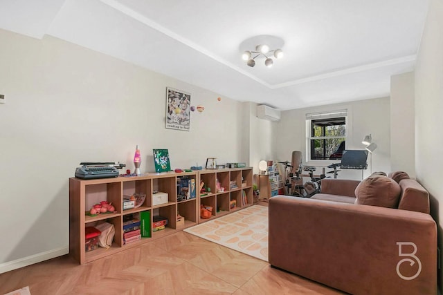 living room with baseboards, a tray ceiling, and a wall mounted AC