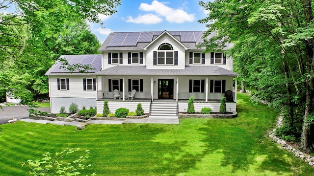 309 Quannacut Rd, Pine Bush, NY 12566 - view of front of house with a porch, roof mounted solar panels, a front yard, and a shingled roof