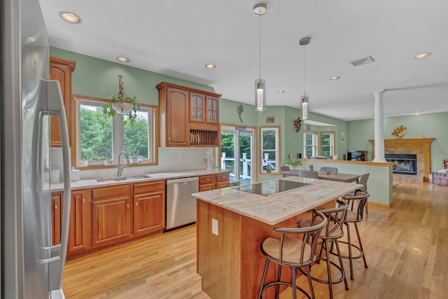 309 Quannacut Rd, Pine Bush, NY 12566 - kitchen with appliances with stainless steel finishes, a sink, a center island, light wood-style floors, and brown cabinetry