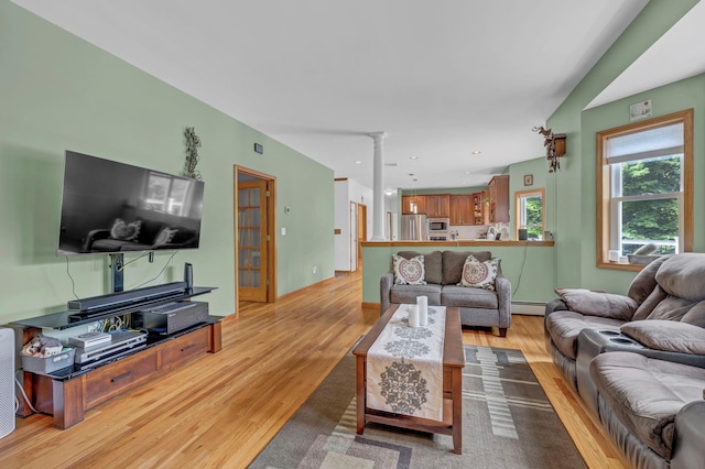 309 Quannacut Rd, Pine Bush, NY 12566 - living area featuring light wood-type flooring, a baseboard radiator, and ornate columns