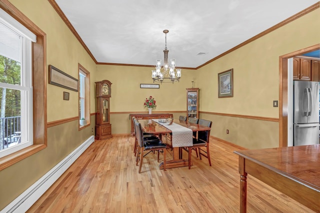 309 Quannacut Rd, Pine Bush, NY 12566 - dining space featuring a baseboard radiator, light wood-type flooring, a chandelier, and crown molding