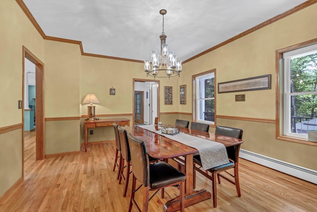 309 Quannacut Rd, Pine Bush, NY 12566 - dining area with light wood-type flooring, baseboard heating, ornamental molding, a chandelier, and baseboards