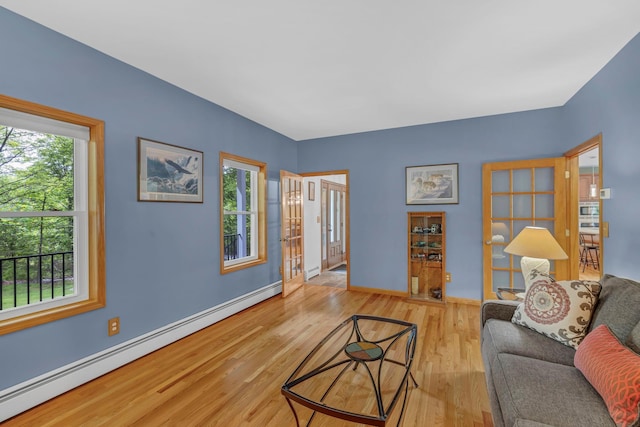 309 Quannacut Rd, Pine Bush, NY 12566 - living room with a baseboard radiator, plenty of natural light, wood finished floors, and a baseboard heating unit
