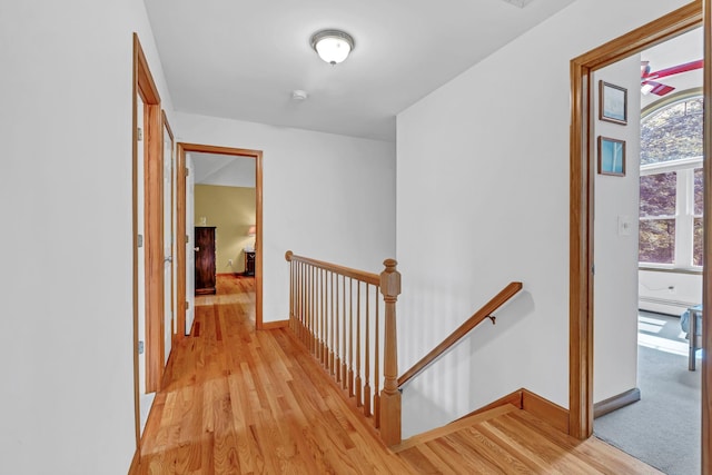 309 Quannacut Rd, Pine Bush, NY 12566 - hallway with an upstairs landing, a baseboard heating unit, light wood-style floors, and baseboards