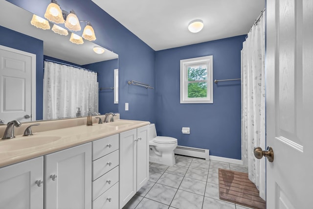 309 Quannacut Rd, Pine Bush, NY 12566 - bathroom with baseboard heating, double vanity, toilet, and baseboards