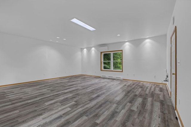 309 Quannacut Rd, Pine Bush, NY 12566 - unfurnished room featuring a wall unit AC, wood finished floors, a baseboard heating unit, baseboards, and recessed lighting