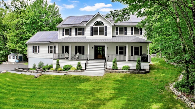 309 Quannacut Rd, Pine Bush, NY 12566 - colonial home with a porch, solar panels, and a front yard
