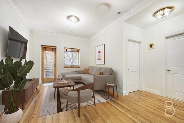 living area with light wood-style flooring, baseboards, and crown molding