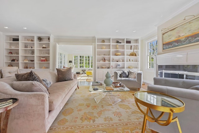 living area featuring recessed lighting, ornamental molding, built in shelves, and wood finished floors