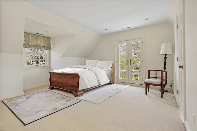carpeted bedroom with visible vents, vaulted ceiling, access to exterior, and multiple windows