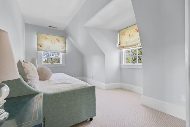 carpeted bedroom featuring baseboards, visible vents, and lofted ceiling