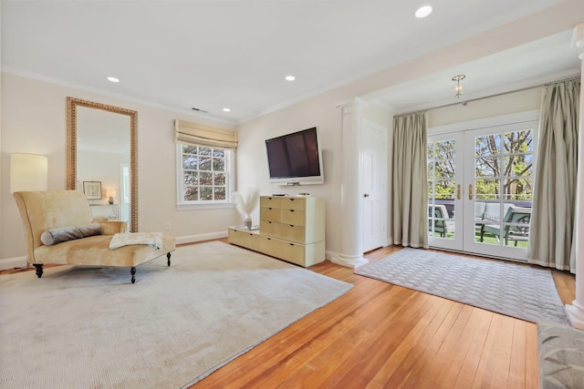 sitting room featuring ornamental molding, a healthy amount of sunlight, and hardwood / wood-style flooring