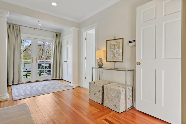 entrance foyer with ornamental molding, decorative columns, recessed lighting, and hardwood / wood-style floors
