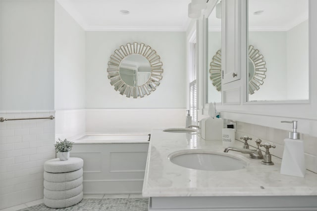 bathroom featuring double vanity, ornamental molding, a sink, and a wainscoted wall