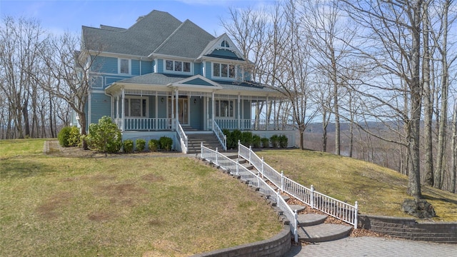 view of front of property featuring a porch, a shingled roof, a front lawn, and stairway