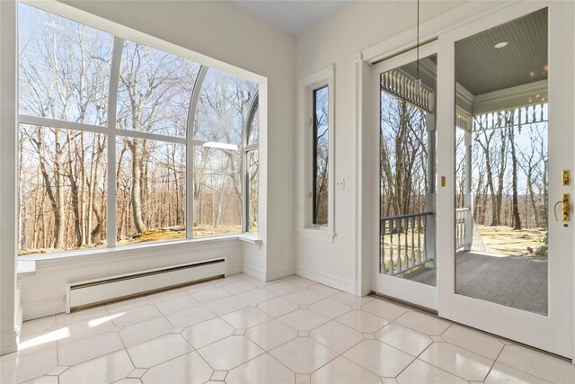 unfurnished sunroom with baseboard heating and plenty of natural light