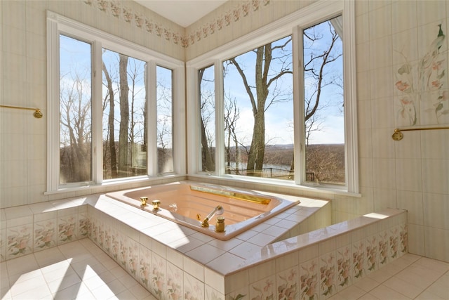 full bath featuring a bath and tile patterned floors