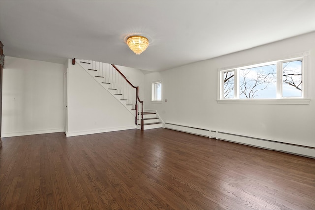 unfurnished living room featuring dark wood finished floors, baseboards, and stairs