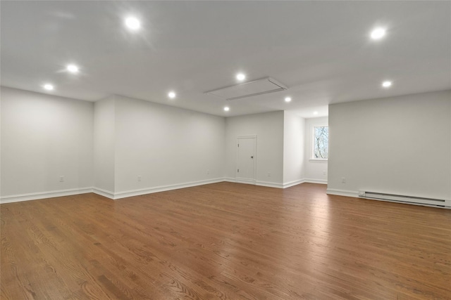 spare room featuring recessed lighting, attic access, and baseboard heating