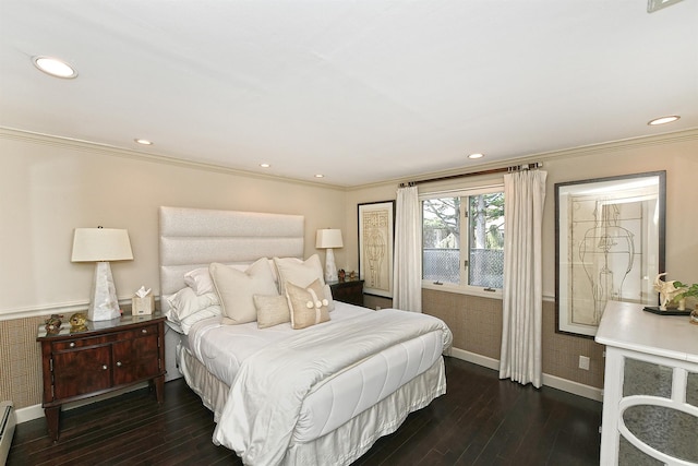 bedroom featuring a baseboard heating unit, hardwood / wood-style floors, baseboards, and ornamental molding