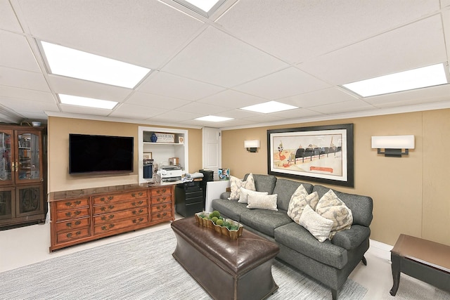 living room featuring a paneled ceiling and carpet floors
