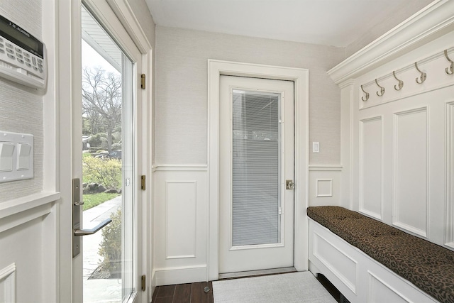 mudroom with wainscoting, a decorative wall, and dark wood-style flooring