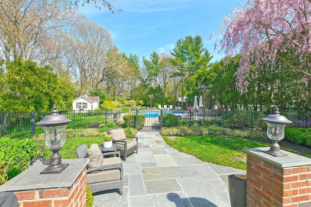 view of home's community featuring fence, an outdoor hangout area, a yard, a patio area, and a swimming pool