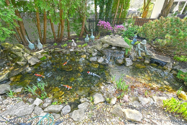 details with fence and a small pond