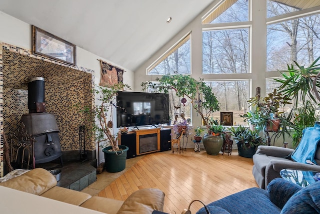 225 Toleman Rd, Washingtonville, NY 10992 - living area featuring plenty of natural light, a wood stove, high vaulted ceiling, and hardwood / wood-style flooring