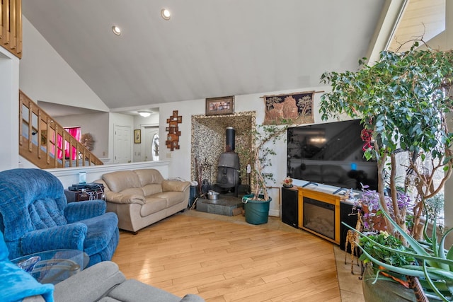 225 Toleman Rd, Washingtonville, NY 10992 - living room with vaulted ceiling, a wood stove, hardwood / wood-style flooring, stairs, and recessed lighting