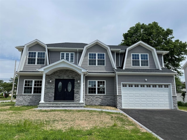 130 Syosset Woodbury Rd, Syosset, NY 11791 - view of front facade featuring an attached garage, driveway, stone siding, and a front lawn