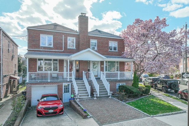 view of front of home with an attached garage, aphalt driveway, brick siding, a porch, and stairs