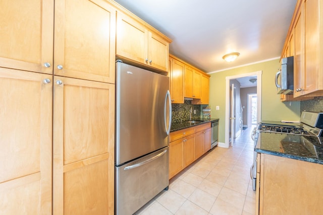 kitchen featuring light tile patterned floors, light brown cabinets, decorative backsplash, and appliances with stainless steel finishes