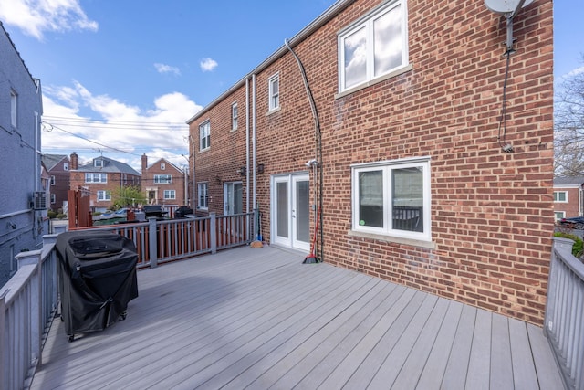 wooden terrace featuring french doors and grilling area
