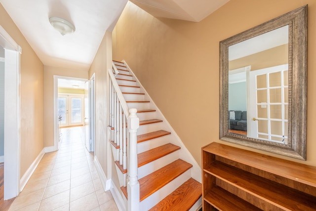 staircase with baseboards and tile patterned flooring