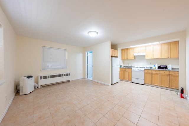 kitchen with radiator, white appliances, under cabinet range hood, a sink, and light countertops