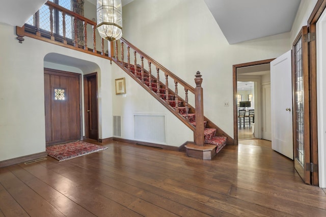 86 Hereford Rd, Bronxville, NY 10708 - foyer featuring arched walkways, hardwood / wood-style flooring, plenty of natural light, and a high ceiling
