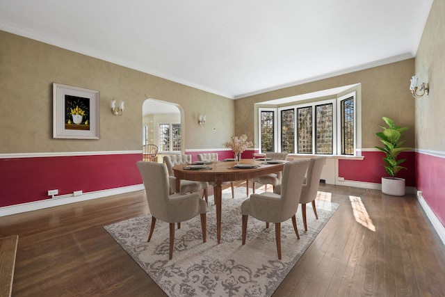 86 Hereford Rd, Bronxville, NY 10708 - dining area with arched walkways, hardwood / wood-style flooring, baseboards, and ornamental molding