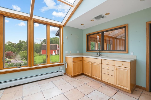 370 Forest Rd, Wallkill, NY 12589 - kitchen with a baseboard heating unit, a sink, light countertops, light brown cabinetry, and a skylight