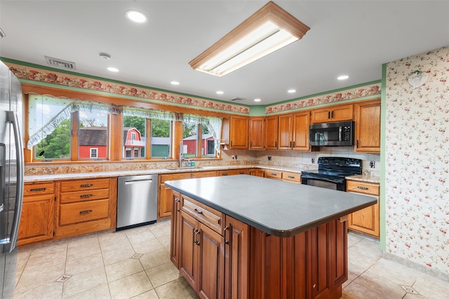 370 Forest Rd, Wallkill, NY 12589 - kitchen with appliances with stainless steel finishes, a sink, a kitchen island, brown cabinetry, and light tile patterned flooring