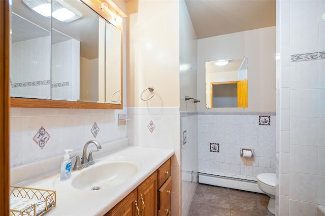 370 Forest Rd, Wallkill, NY 12589 - bathroom with tile walls, a baseboard heating unit, tile patterned flooring, toilet, and vanity