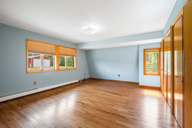 370 Forest Rd, Wallkill, NY 12589 - empty room with light wood-style flooring, baseboards, and a baseboard radiator