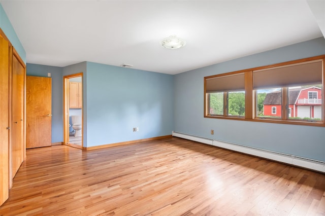 370 Forest Rd, Wallkill, NY 12589 - empty room featuring a baseboard radiator, light wood-type flooring, and baseboards