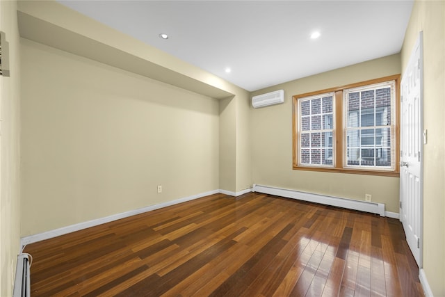 spare room featuring dark wood-style flooring, baseboards, a baseboard heating unit, and a wall unit AC