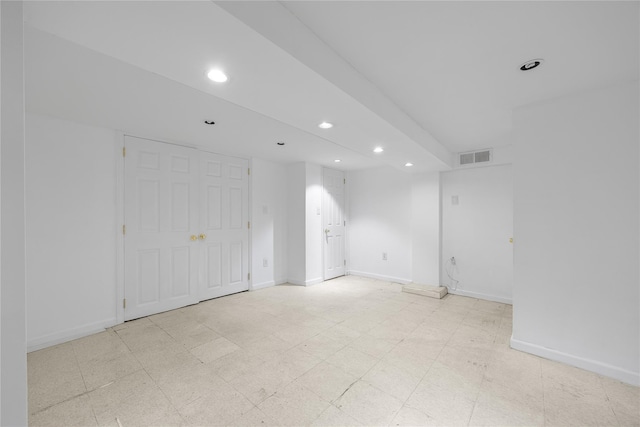 spare room featuring visible vents, baseboards, recessed lighting, and light floors