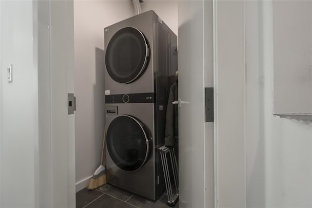 1043 Halsey St Unit 4, Brooklyn, NY 11207 - laundry room featuring dark tile patterned flooring and stacked washer / drying machine