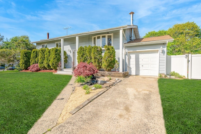 view of front of property with fence, an attached garage, driveway, and a front yard
